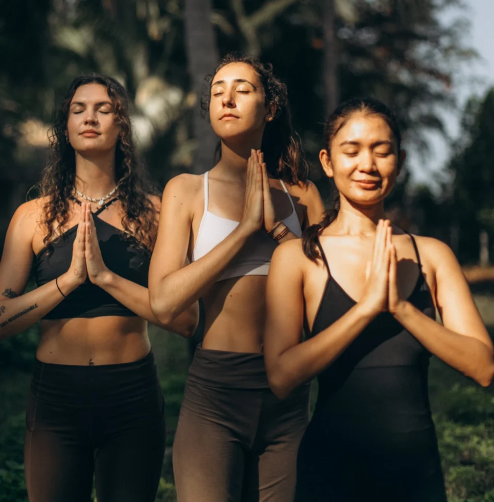 Yoga teacher training students practicing outdoor meditation in Thailand