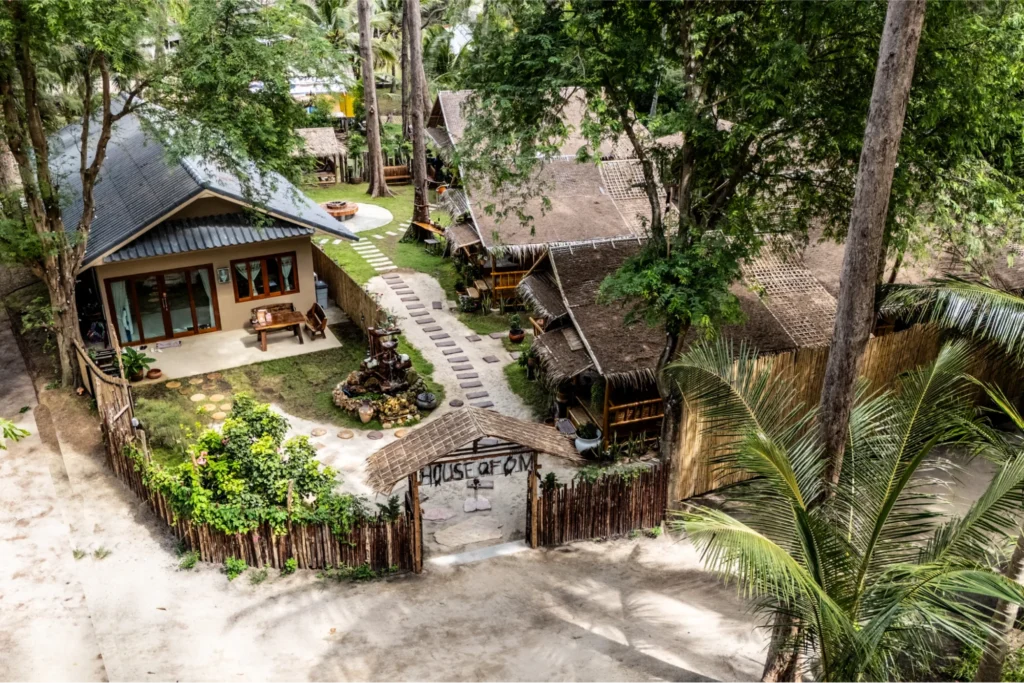 Aerial view of House of Om yoga teacher training accommodation surrounded by tropical trees in Koh Phangan, Thailand