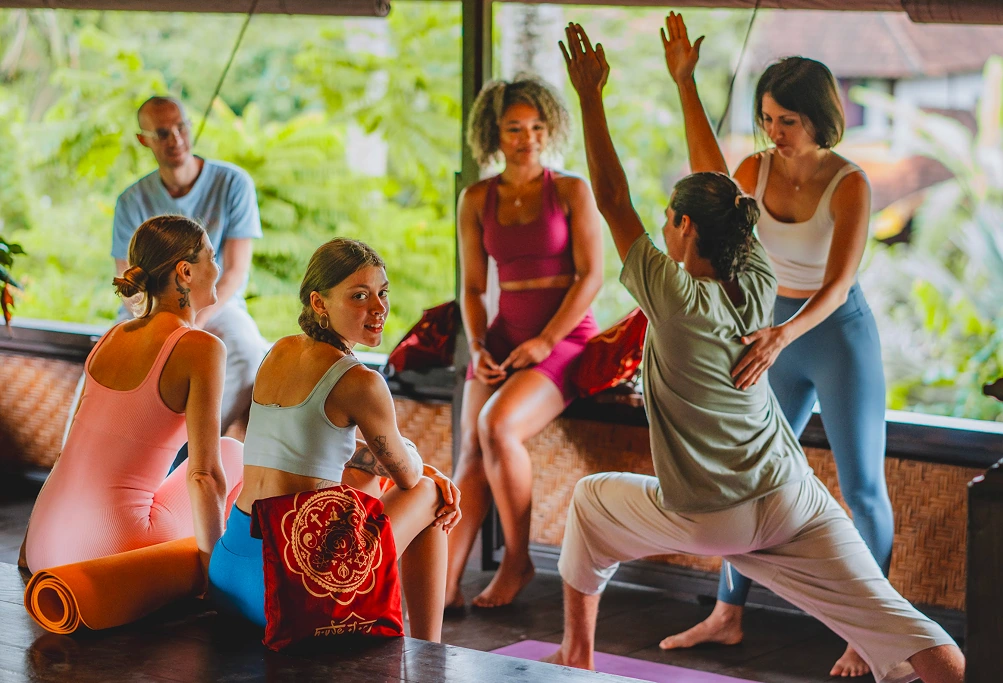 Yoga teacher demonstrating proper alignment during a 200-hour Yoga Teacher Training class at House of Om Bali.