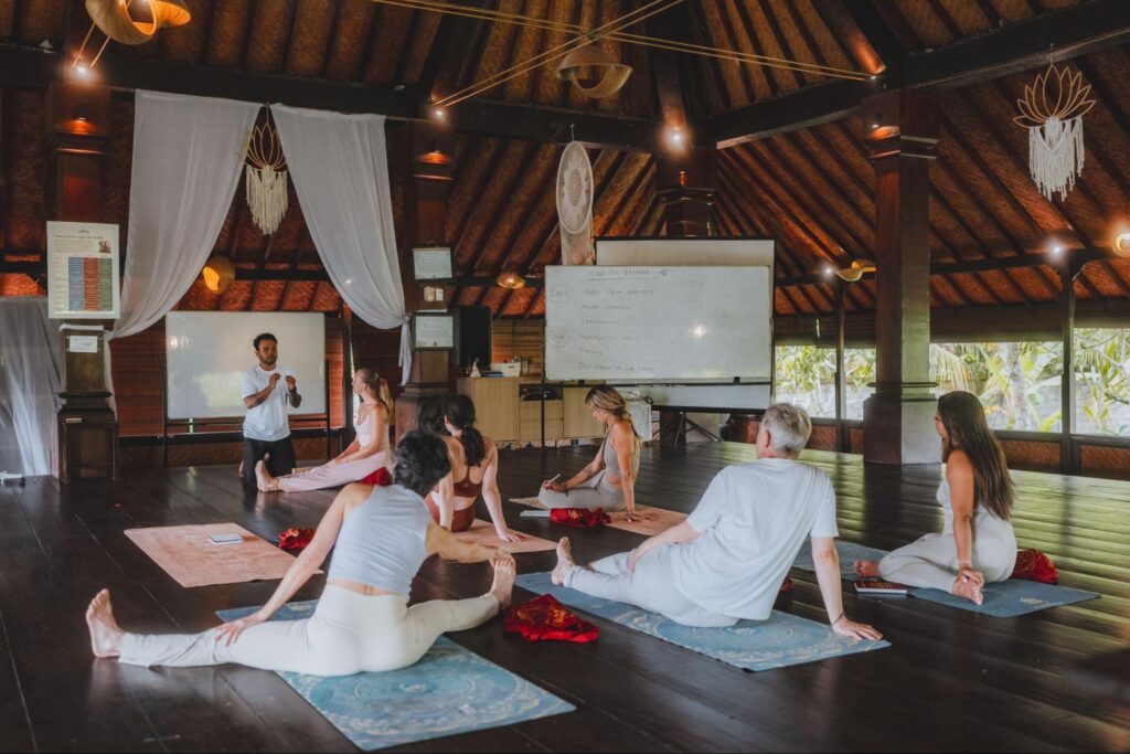 Students attending a yoga philosophy and breathwork lecture during a Yoga Alliance-certified teacher training at House of Om Bali.