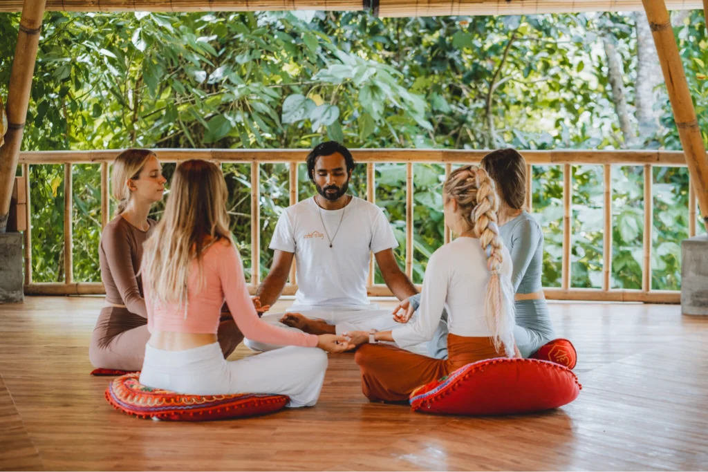 Yoga teacher leading students in a group meditation session during Yoga Teacher Training at House of Om Bali.