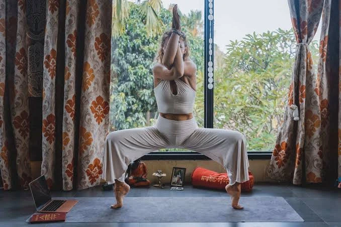Yoga student practicing a standing yoga pose during teacher training in Thailand
