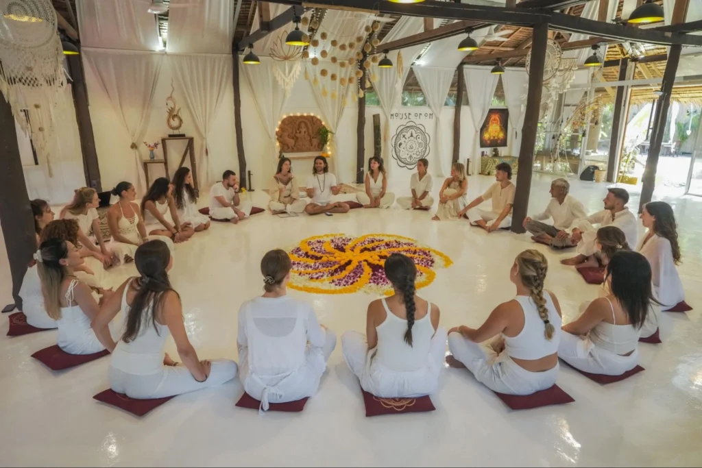 House of Om yoga teacher training students seated in a circle during a ceremony in Thailand