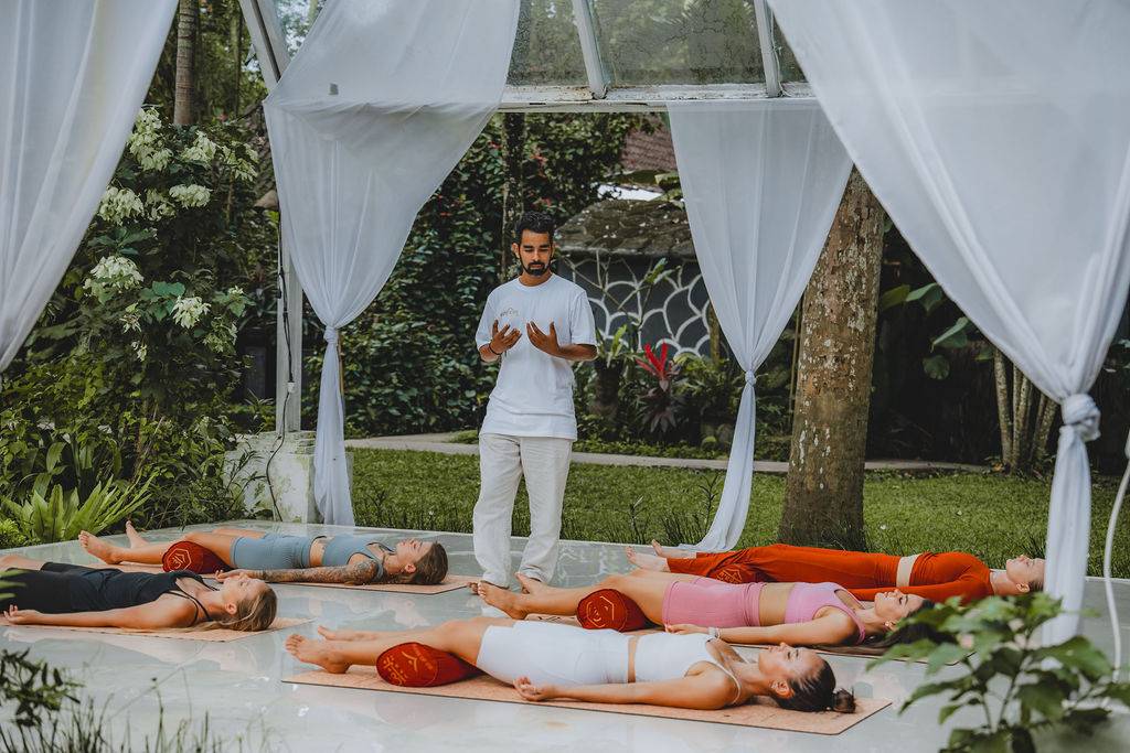 Yoga teacher guiding students through Savasana during beginner-friendly 200-hour yoga teacher training in Bali