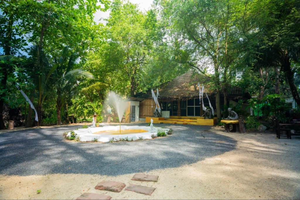 House of Om yoga training campus surrounded by tropical trees in Thailand
