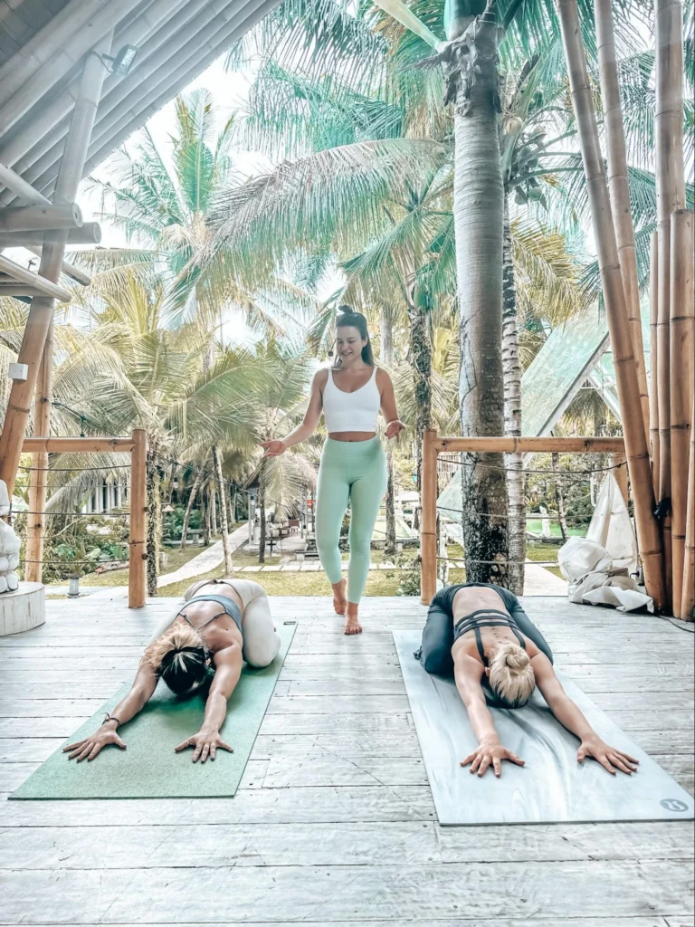 Yoga teacher observing students in child’s pose during yoga teacher training in Ubud