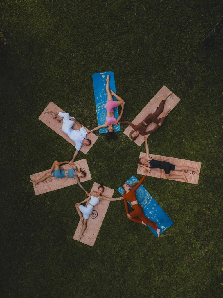 Aerial view of yoga teacher training students relaxing on mats outdoors in Bali