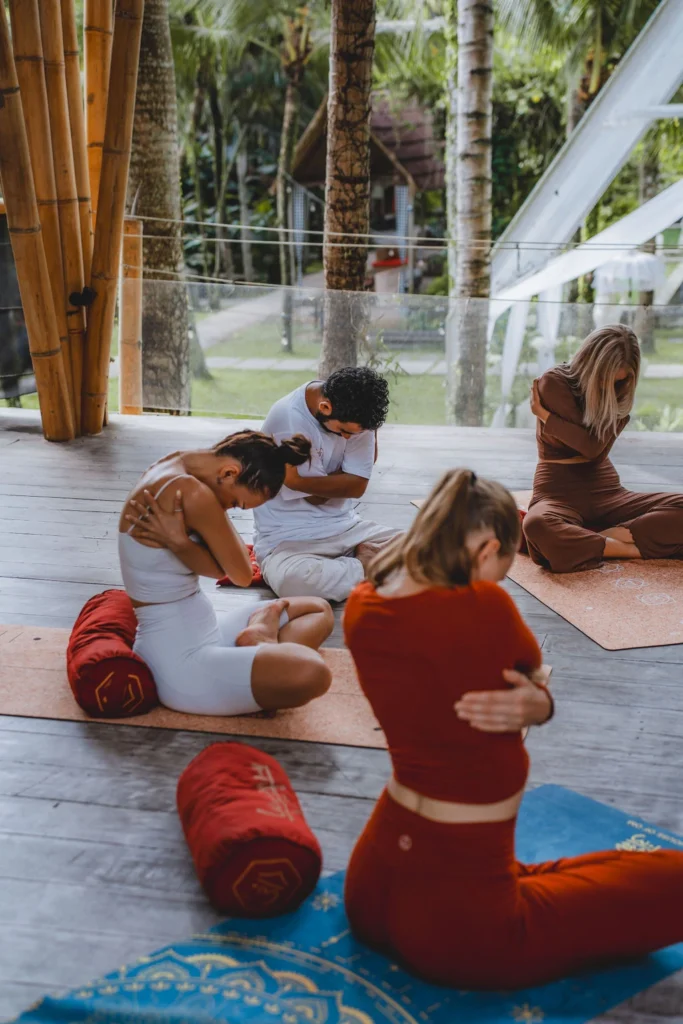 Students practicing a seated self-awareness exercise during yoga teacher training at The Mansion in Bali