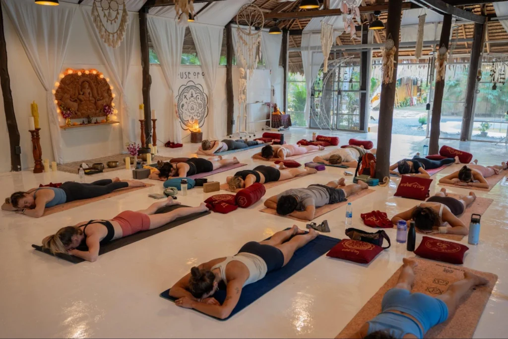 Yoga teacher training students resting during a group yoga class at House of Om Thailand