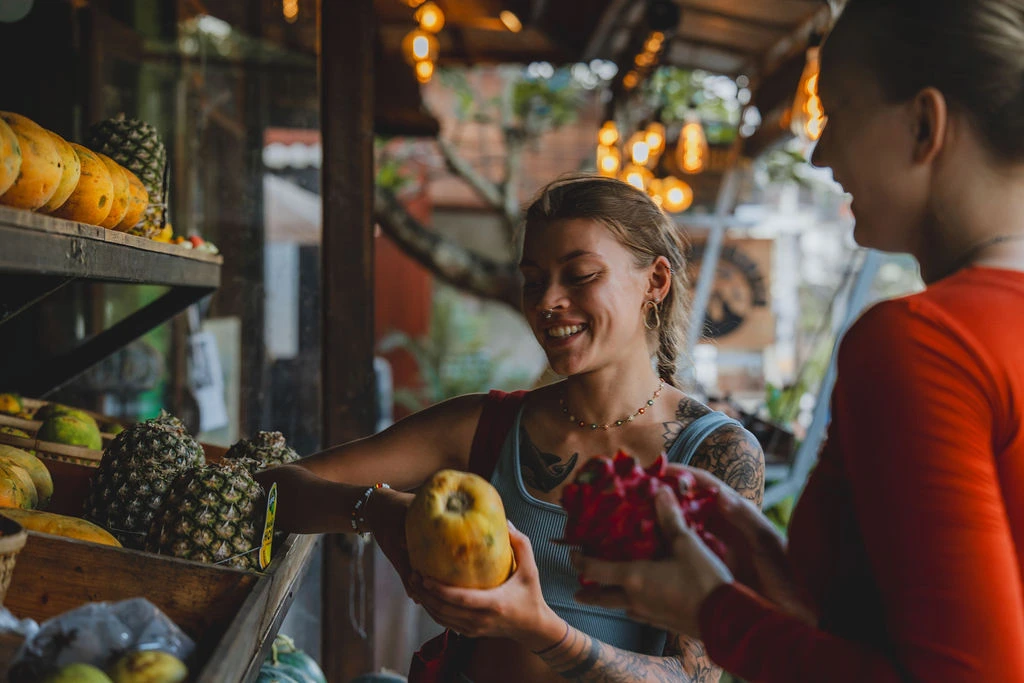 Yoga teacher training students choosing fresh tropical fruit during free time in Bali