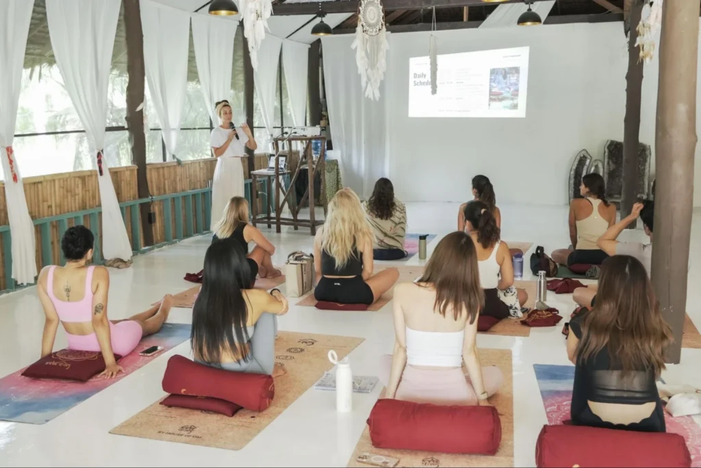 Yoga teacher explaining the daily schedule to students during House of Om teacher training