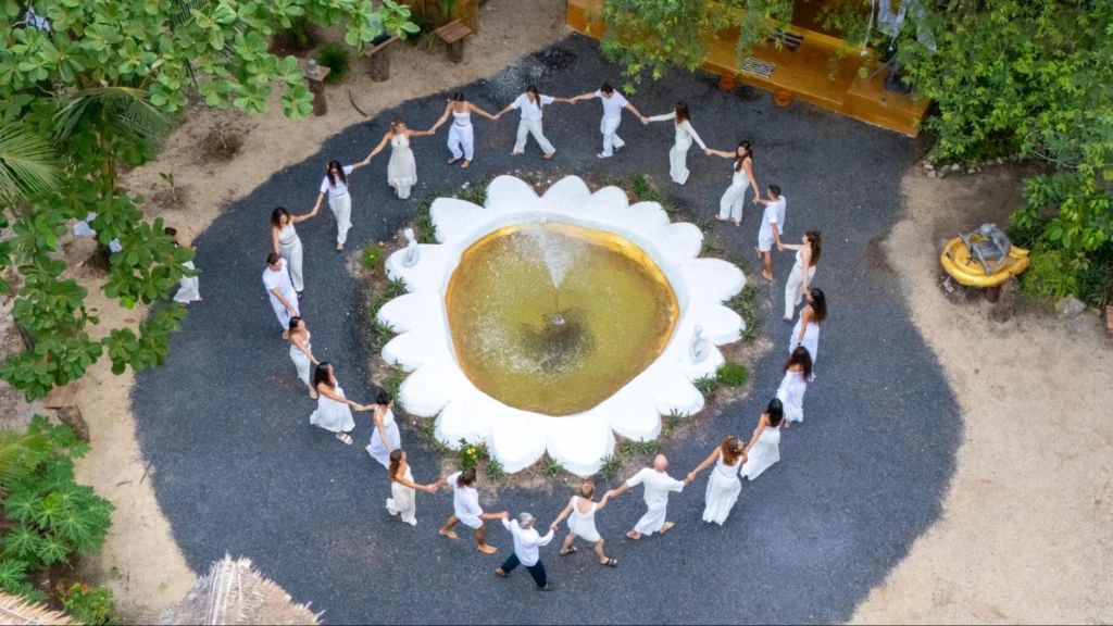 House of Om yoga teacher training students forming a circle during a graduation ceremony in Thailand