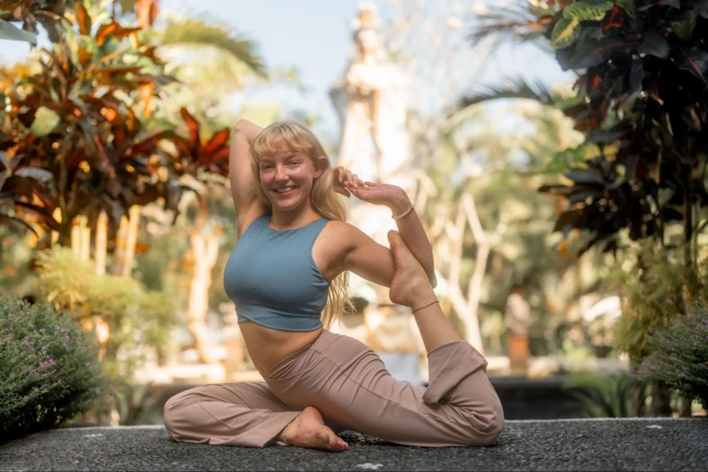 Yoga student practicing a seated backbend outdoors at Amertham in Bali
