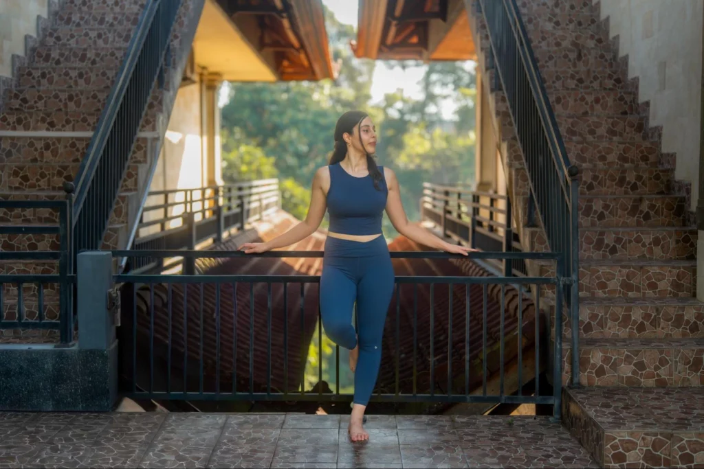 Yoga student balancing outdoors during Amertham yoga teacher training in Bali