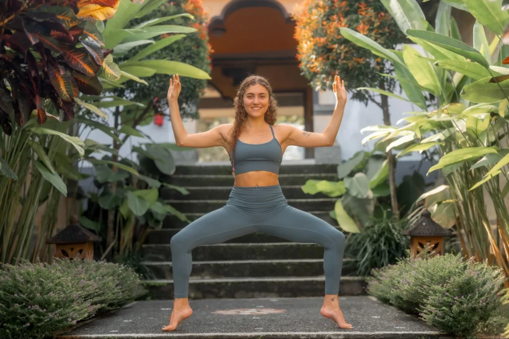 Yoga student practicing goddess pose outdoors during yoga teacher training in Bali