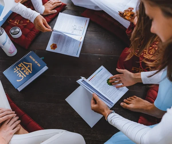 Yoga teacher training students studying course materials together in Bali